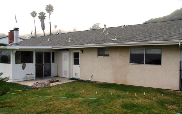 Old patio cover removed, gound staked out for new patio.